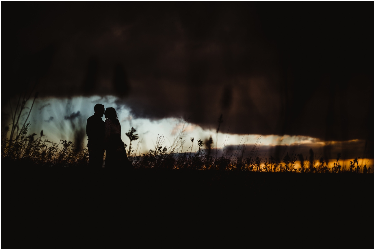 Silhouette of a couple cuddling together at sunrise